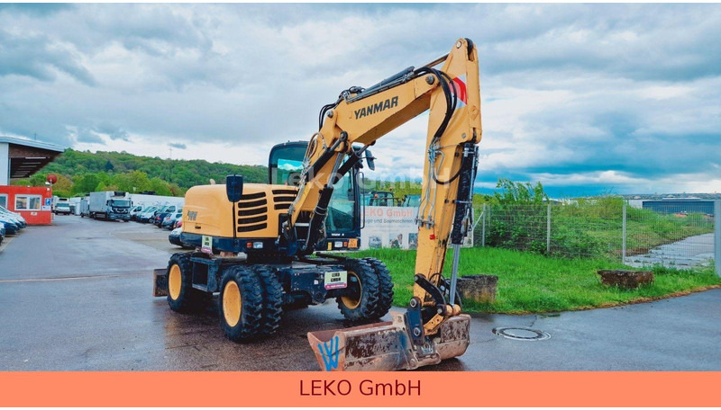Yanmar B 95W Mit Drei Löffeln und Ein Hammer - Kolesové rýpadlo: obrázek 1 Yanmar B 95W Mit Drei Löffeln und Ein Hammer - Kolesové rýpadlo: obrázek 1